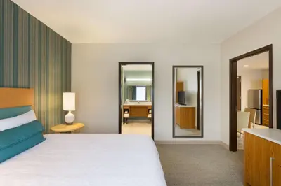 a hotel room with a bed and a mirror at Home2 Suites by Hilton Downingtown Exton Route 30 in Downingtown