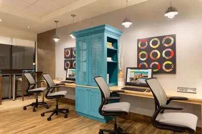 an office with a blue cabinet and desks and chairs at Home2 Suites by Hilton Downingtown Exton Route 30 in Downingtown