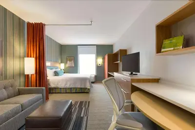 a hotel room with a bed and a living room at Home2 Suites by Hilton Downingtown Exton Route 30 in Downingtown