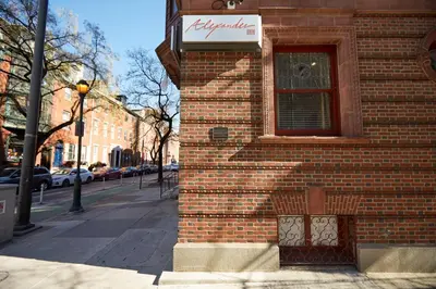 a brick building with a window on a street at Alexander Inn in Philadelphia