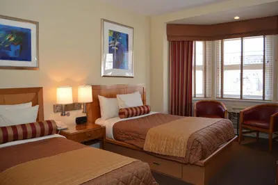 a hotel room with two beds and a window at Alexander Inn in Philadelphia