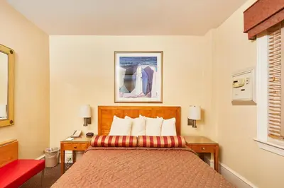 a hotel room with a bed and two night stands at Alexander Inn in Philadelphia