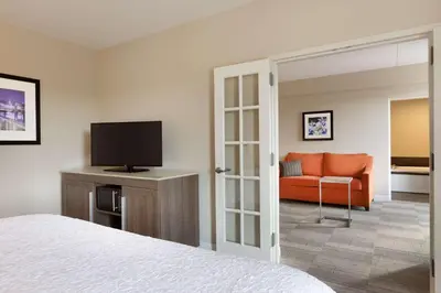 a hotel room with a bed and a couch at Hampton Inn Denville-Rockaway-Parsippany in Denville