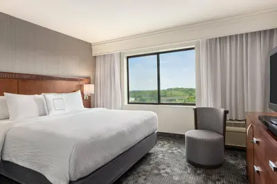 a hotel room with a bed and a television at Courtyard by Marriott Philadelphia Montgomeryville in North Wales