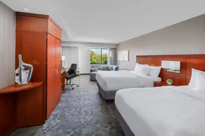 a hotel room with two beds and a desk at Courtyard by Marriott Philadelphia Montgomeryville in North Wales
