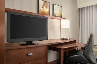 a hotel room with a television and a desk with a chair at Courtyard by Marriott Philadelphia Montgomeryville in North Wales