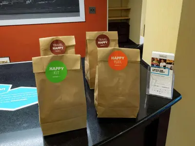 three brown bags sitting on a counter with stickers on them at Hampton Inn Hazleton in Hazleton