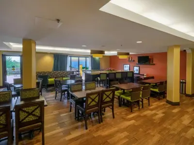 a restaurant with tables and chairs in a room at Hampton Inn Hazleton in Hazleton
