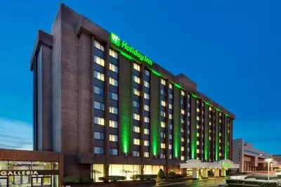 a hotel building with a green sign on it at Holiday Inn Binghamton-Downtown Hawley Street by IHG in Binghamton