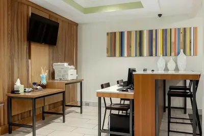 an office with two desks and a computer on a wall at Holiday Inn Express Hotel & Suites Binghamton University-Vestal by IHG in Vestal