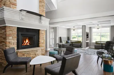 a living room with a fireplace and chairs at Residence Inn by Marriott Philadelphia Langhorne in Langhorne