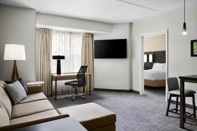 a hotel room with a couch and a desk and a bed at Residence Inn by Marriott Philadelphia Langhorne in Langhorne