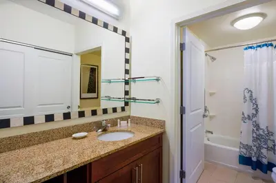 a bathroom with a sink and a mirror and a shower at Residence Inn by Marriott Philadelphia Langhorne in Langhorne