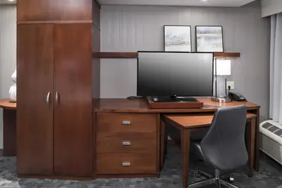 an office with a desk with a computer and a chair at Courtyard by Marriott West Orange in West Orange