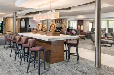 a lobby with a breakfast bar with stools at Courtyard by Marriott West Orange in West Orange