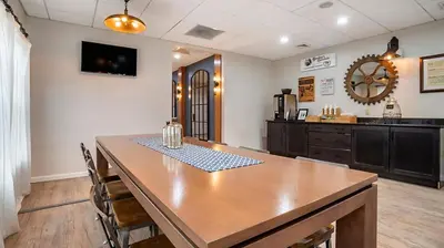 a dining room with a table and a kitchen at Bluegreen Vacations Suites at Hershey in Hershey