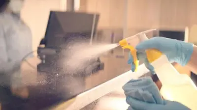 a person in blue gloves spraying a window with a brush at Bluegreen Vacations Suites at Hershey in Hershey