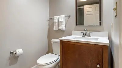 a bathroom with a toilet and a sink and a mirror at Bluegreen Vacations Suites at Hershey in Hershey
