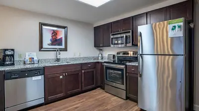 a kitchen with wooden cabinets and a stainless steel refrigerator at Bluegreen Vacations Suites at Hershey in Hershey