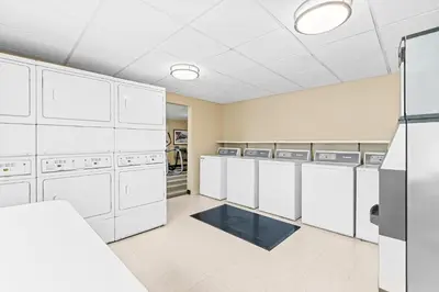 a laundry room with white cabinets and appliances at Candlewood Suites Hazleton by IHG in Hazleton