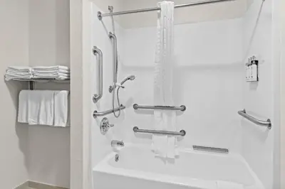 a bathroom with a shower and a bath tub at Candlewood Suites Hazleton by IHG in Hazleton