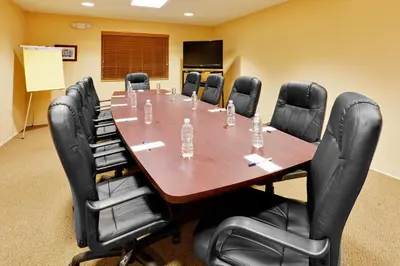 a conference room with a large wooden table and chairs at Candlewood Suites Hazleton by IHG in Hazleton