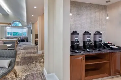 a hotel lobby with two coffee machines on a counter at Residence Inn Wayne in Wayne
