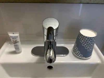 a sink with a faucet and two cups on it at Hotel Richland LES in New York