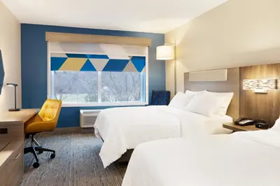 a hotel room with two beds and a window at Holiday Inn Express Hotel & Suites Drums-Hazelton by IHG in Drums