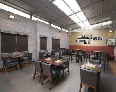 a dining room with tables and chairs and a chalkboard at Fairfield Inn & Suites by Marriott New York Manhattan/Fifth Avenue in New York