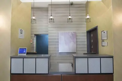 a waiting room with a desk with a laptop on it at Fairfield Inn & Suites by Marriott New York Manhattan/Fifth Avenue in New York