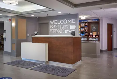 a welcome to the very store sly sign in a store lobby at Hampton Inn by Hilton Harrisburg West in Mechanicsburg