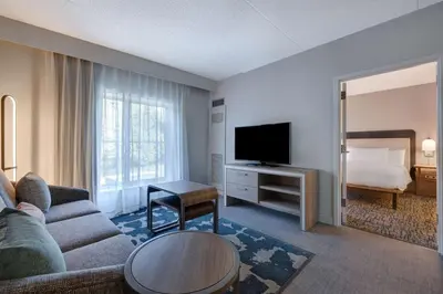 a living room with a couch and a tv and a bed at Homewood Suites Lansdale in Lansdale