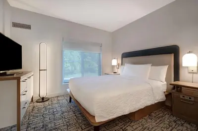 a hotel room with a bed and a television at Homewood Suites Lansdale in Lansdale
