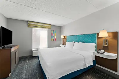 a hotel room with a bed and a television at Hampton Inn & Suites Newtown in Yardley