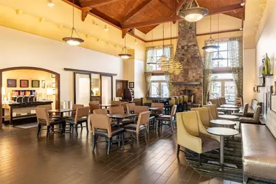 a restaurant with tables and chairs in a room at Hampton Inn & Suites Newtown in Yardley