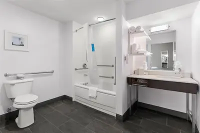 a bathroom with a toilet and a sink and a shower at Hampton Inn & Suites Newtown in Yardley