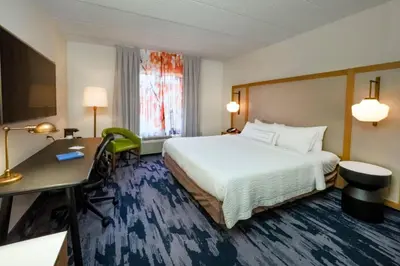 a hotel room with a bed and a desk at Fairfield Inn by Marriott Hazleton in Hazleton