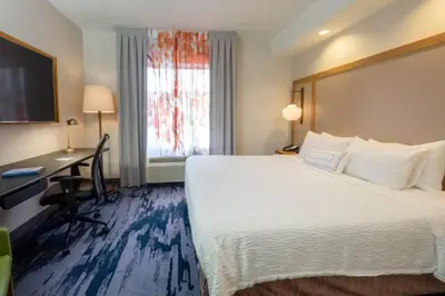 a hotel room with a large bed and a desk at Fairfield Inn by Marriott Hazleton in Hazleton
