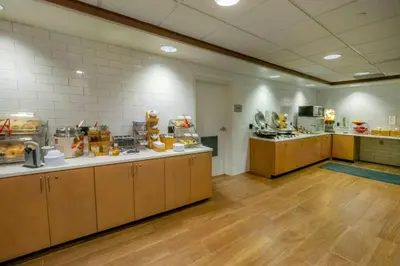 a large kitchen with wooden counter tops in a cafeteria at Fairfield Inn by Marriott Hazleton in Hazleton