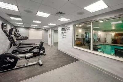 a fitness room with a swimming pool and a gym at Fairfield Inn by Marriott Hazleton in Hazleton