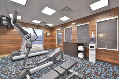 a gym with two exercise bikes and a television at Fairfield Inn and Suites by Marriott Williamsport in Williamsport