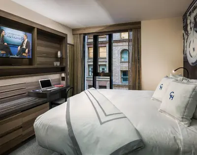 a hotel room with a bed and a tv at Carnegie Hotel in New York