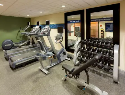 a gym with several treadmills and cardio machines at Hampton Inn South Plainfield-Piscataway in South Plainfield