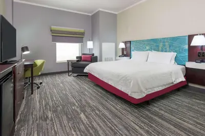 a hotel room with a bed and a desk at Hampton Inn South Plainfield-Piscataway in South Plainfield