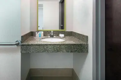a bathroom with a sink and a mirror at Hampton Inn South Plainfield-Piscataway in South Plainfield