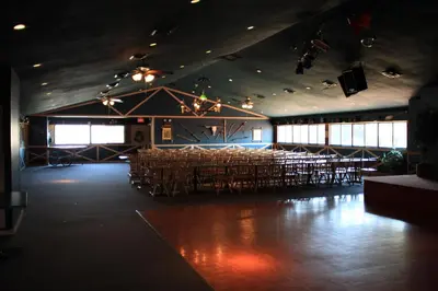 a large room with tables and chairs in a building at Circle M Camping Resort Loft Park Model in Wabank