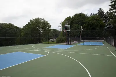 a basketball hoop on a tennis court at Circle M Camping Resort Screened Park Model in Wabank