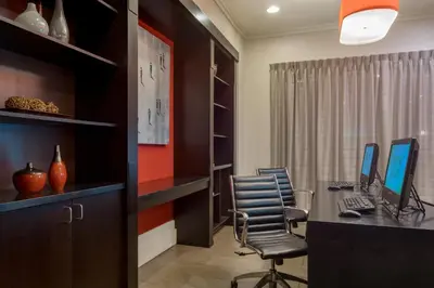 an office with a desk with two computers on it at Holiday Inn Harrisburg I-81 Hershey Area by IHG in Grantville