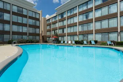 a large swimming pool in front of a building at Holiday Inn Harrisburg I-81 Hershey Area by IHG in Grantville